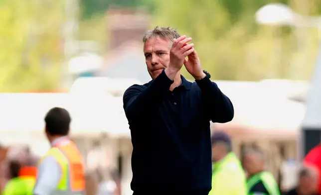 Wrexham manager Phil Parkinson applauds the fans following the EFL Championship soccer match between Wrexham and Middlesbrough, in Wrexham, Wales, Saturday May 2, 2026. (Cody Froggatt/PA via AP)