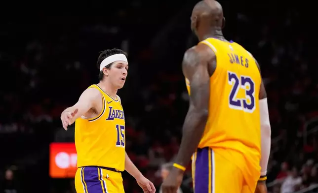 Los Angeles Lakers guard Austin Reaves (15) celebrates with forward LeBron James (23) during the second half of Game 6 of a first-round NBA playoffs basketball series against the Houston Rockets in Houston, Friday, May 1, 2026. (AP Photo/Ashley Landis)