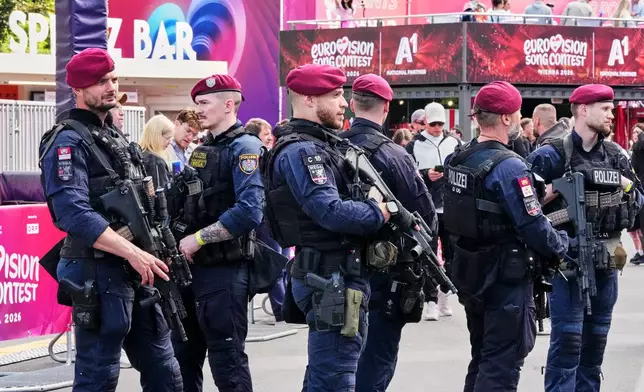 Police patrols with heavy weapons at the Eurovision Village during the 70th Eurovision Song Contest week in Vienna, Austria, Wednesday, May 13, 2026. (AP Photo/Martin Meissner)