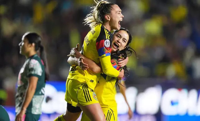 Irene Guerrero of Mexico's America, top, is congratulated after scoring her side's 4th goal against The United States' Washington Spirit during the Women's CONCACAF Champions Cup final soccer match in Pachuca, Mexico, Saturday, May 23, 2026.(AP Photo/Fernando Llano)