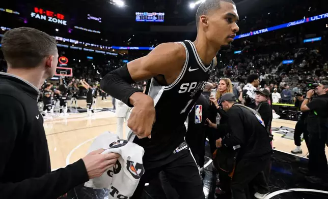 San Antonio Spurs forward Victor Wembanyama (1) leaves the court after the second half of Game 6 in the Western Conference finals NBA basketball playoffs series, Thursday, May 28, 2026, in San Antonio. (AP Photo/Darren Abate)