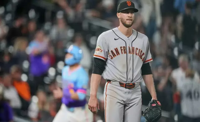 San Francisco Giants relief pitcher Caleb Kilian reacts after giving up a three-run home run to Colorado Rockies' Hunter Goodman in the ninth inning of a baseball game Friday, May 29, 2026, in Denver. (AP Photo/David Zalubowski)