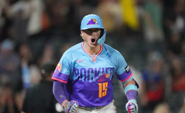Colorado Rockies' Hunter Goodman reacts as he heads up the first-base line after connecting for a three-run home run off San Francisco Giants relief pitcher Caleb Kilian in the ninth inning of a baseball game Friday, May 29, 2026, in Denver. (AP Photo/David Zalubowski)