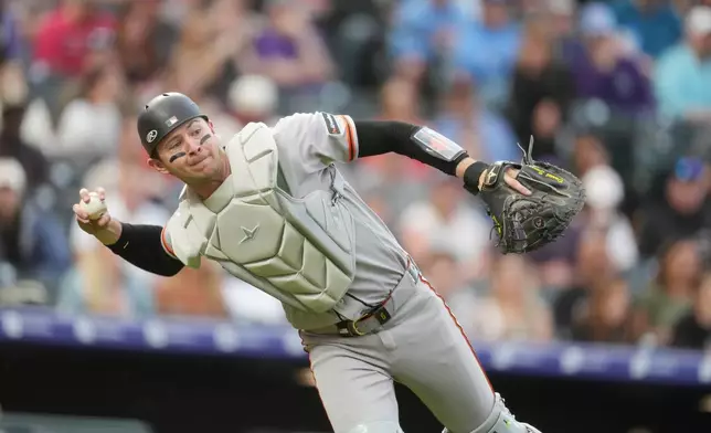 San Francisco Giants catcher Daniel Susac thorws to first base to put out Colorado Rockies' Willi Castro in the fourth inning of a baseball game Friday, May 29, 2026, in Denver. (AP Photo/David Zalubowski)