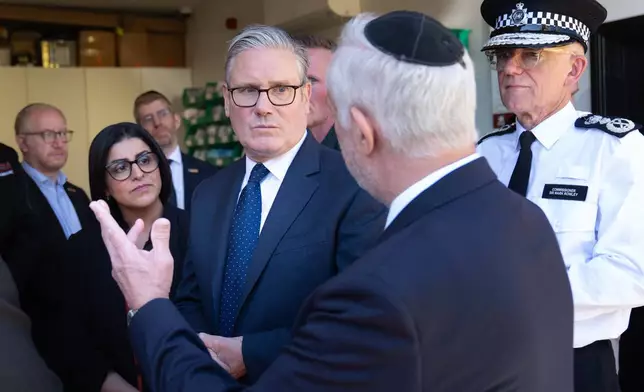 Britain's Prime Minister Keir Starmer, center, Metropolitan Police Commissioner Mark Rowley, right, and Home Secretary Shabana Mahmood, 2nd left, speak with members of the Jewish community during a visit to Golders Green, north west London, Thursday April 30, 2026, following an attack on Wednesday in which two men were stabbed. (Stefan Rousseau/Pool via AP)
