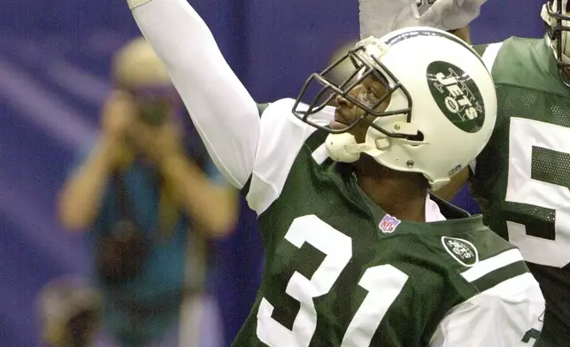 FILE - New York Jets cornerback Aaron Glenn (31) celebrates his interception oduring the first half of an NFL football game against the New Orleans Saints, Nov. 4, 2001, in New Orleans. (AP Photo/Andrew Cohoon, File)