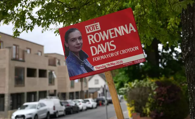 An election campaign poster is displayed at a shop for the upcoming local council elections, in London, Wednesday, May 6, 2026. (AP Photo/Kin Cheung)
