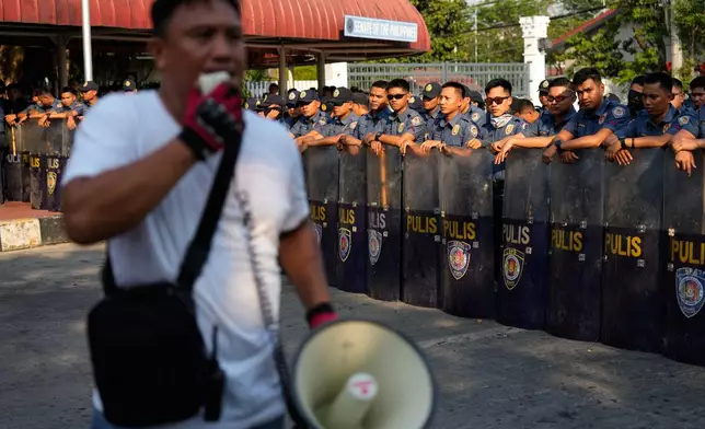Policemen secure the perimeter of the Philippine Senate as supporters of Senator Ronald dela Rosa and Vice President Sara Duterte hold rallies in Pasay, Philippines on Tuesday, May 12, 2026. (AP Photo/Aaron Favila)