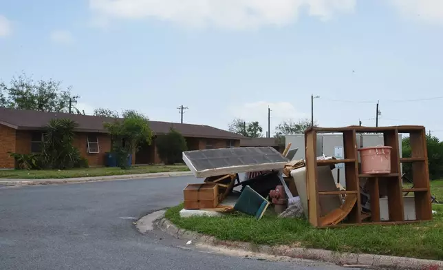 A pile of furniture is seen in a public housing subdivision in Port Isabel, Texas, on April 13, 2026. (AP Photo/Valerie Gonzalez)