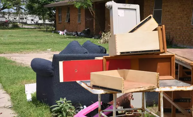 A pile of furniture is piled in a public housing subdivision in Port Isabel, Texas, on April 13, 2026. (AP Photo/Valerie Gonzalez)