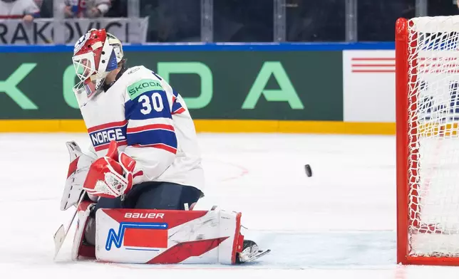 Norway's goaltender Tobias Normann, concedes a goal during the 2026 IIHF Men's Ice Hockey World Championship preliminary round group B game between Slovakia and Norway, in Fribourg, Switzerland, Saturday, May 16, 2026. (Cyril Zingaro/Keystone via AP)