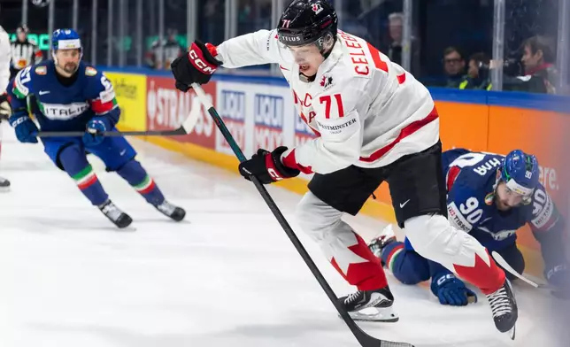 Canada's Macklin Celebrini in action, during the 2026 IIHF Men's Ice Hockey World Championship preliminary round group B game between Italy and Canada, in Fribourg, Switzerland, Saturday, May 16, 2026. (Cyril Zingaro/Keystone via AP)