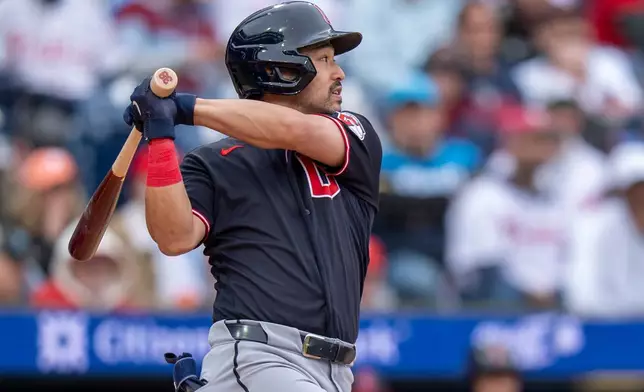 Cleveland Guardians' Steven Kwan hits a single to score Daniel Schneemann during the fifth inning of a baseball game against the Philadelphia Phillies, Sunday, May 24, 2026, in Philadelphia. (AP Photo/Chris Szagola)