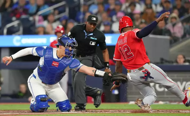 Toronto Blue Jays catcher Brandon Valenzuela, left, tags out Los Angeles Angels' Jorge Soler (12) who grounded out at home plate during second-inning baseball game action in Toronto, Saturday, May 9, 2026. (Chris Young/The Canadian Press via AP)