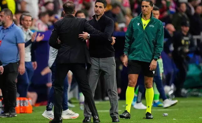 Atletico Madrid's head coach Diego Simeone, left, greets Arsenal's manager Mikel Arteta after a Champions League semifinal, first leg, soccer match between Atletico Madrid and Arsenal in Madrid, Spain, Wednesday, April 29, 2026. (AP Photo/Jose Breton)