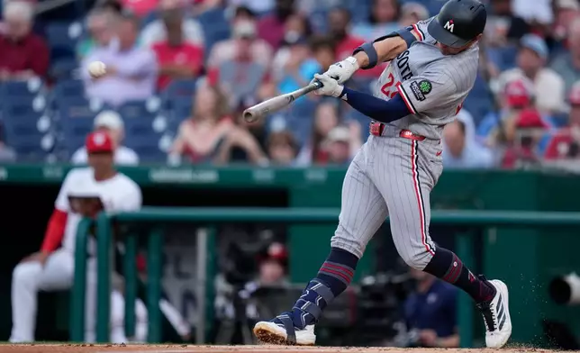 Minnesota Twins' Brooks Lee hits a two RBI double during the second inning of a baseball game against the Washington Nationals, Tuesday, May 5, 2026, in Washington. (AP Photo/Jess Rapfogel)