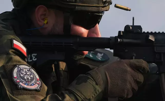 A Polish cadet shoots an M4 service rifle during the Sandhurst Military Skills Competition at the United States Military Academy in West Point, N.Y., Saturday, May 2, 2026. (AP Photo/Julia Demaree Nikhinson)