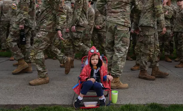 Brixten Hennon, 2, watches cadets compete in the crucible portion of the Sandhurst Military Skills Competition at the United States Military Academy in West Point, N.Y., Saturday, May 2, 2026. (AP Photo/Julia Demaree Nikhinson)