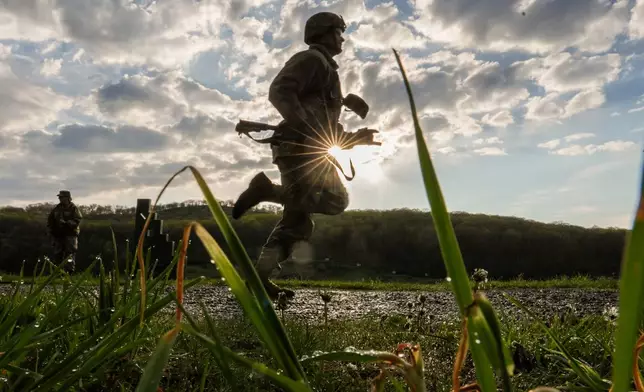 A cadet runs to shoot an M4 service rifle during the Sandhurst Military Skills Competition at the United States Military Academy in West Point, N.Y., Saturday, May 2, 2026. (AP Photo/Julia Demaree Nikhinson)