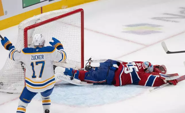 Buffalo Sabres' Jason Zucker (17) celebrates a goal by teammate Konsta Helenius in front of Montreal Canadiens goaltender Jakub Dobes (75) during the second period in Game 6 in a second-round NHL hockey Stanley Cup playoff series in Montreal, Saturday, May 16, 2026. (Christinne Muschi/The Canadian Press via AP)