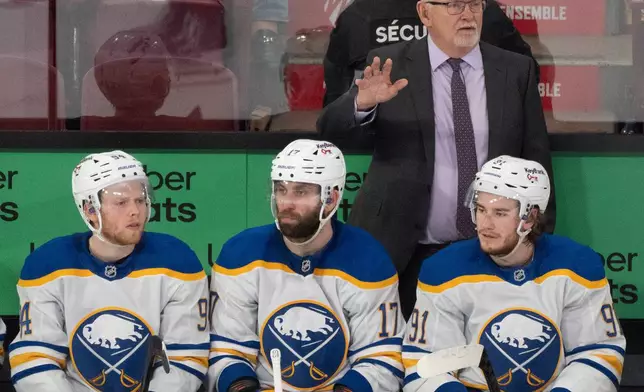 Buffalo Sabres head coach Lindy Ruff, top right, gives instructions from the bench during the third period of Game 6 in a second-round NHL hockey Stanley Cup playoff series against the Montreal Canadiens in Montreal, Saturday, May 16, 2026. (Christinne Muschi/The Canadian Press via AP)