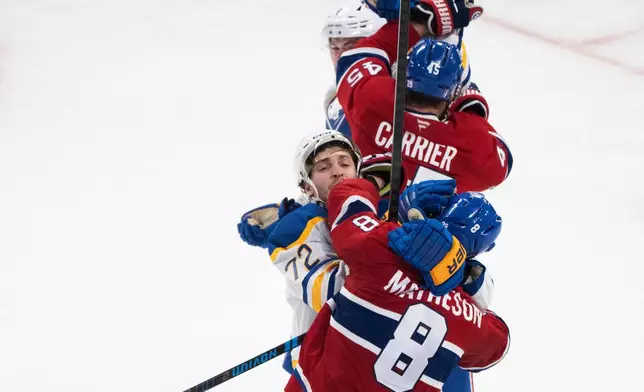 Montreal Canadiens' Mike Matheson (8) and Alexandre Carrier (45) rough it up with Buffalo Sabres' Tage Thompson (72) and Zach Benson, top, during the third period of Game 6 in a second-round NHL hockey Stanley Cup playoff series in Montreal, Saturday, May 16, 2026. (Christinne Muschi/The Canadian Press via AP)
