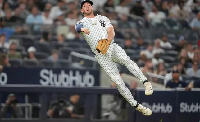 New York Yankees third baseman Ryan McMahon attempts to throw out Toronto Blue Jays' Ernie Clement at first base during the seventh inning of a baseball game, Wednesday, May 20, 2026, in New York. (AP Photo/Yuki Iwamura)