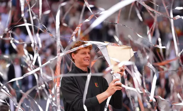 Jannik Sinner, of Italy, holds the trophy after winning the men's singles tennis final match against Alexander Zverev, of Germany, at the Madrid Open tennis tournament in Madrid, Spain, Sunday, May 3, 2026. (AP Photo/Manu Fernandez)