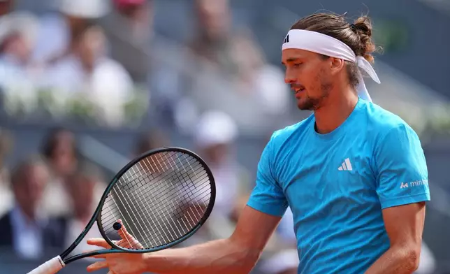 Alexander Zverev, of Germany, grabs his racket during the men's singles tennis final match againstJannik Sinner, of Italy, at the Madrid Open tennis tournament in Madrid, Spain, Sunday, May 3, 2026. (AP Photo/Manu Fernandez)