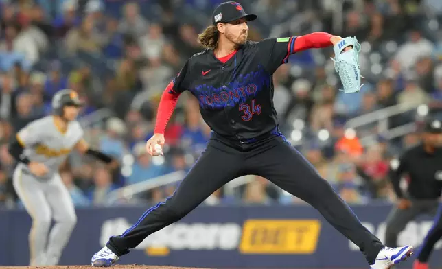 Toronto Blue Jays pitcher Kevin Gausman (34) works against the Pittsburgh Pirates during first inning of a baseball game in Toronto, Friday, May 22, 2026. (Chris Young/The Canadian Press via AP)