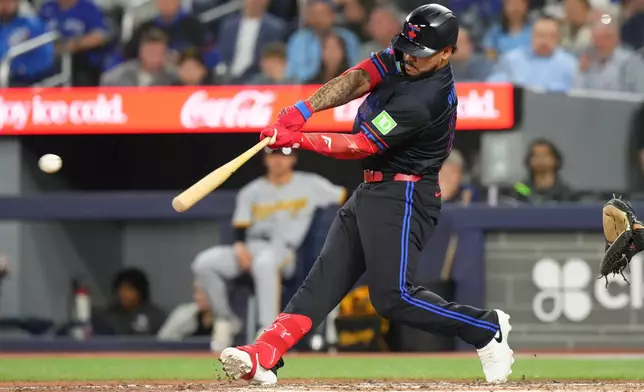 Toronto Blue Jays' Yohendrick Pinango (24) hits a two run RBI double off Pittsburgh Pirates pitcher Bubba Chandler during the third inning of a baseball game in Toronto, Friday, May 22, 2026. (Chris Young/The Canadian Press via AP)