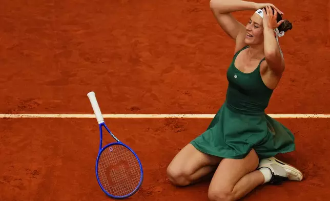 Marta Kostyuk of Ukraine celebrates after defeating Mirra Andreeva during their women's singles final match at the Madrid Open tennis tournament in Madrid, Spain, Saturday, May 2, 2026. (AP Photo/Manu Fernandez)