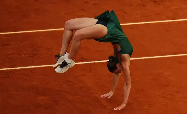 Marta Kostyuk of Ukraine celebrates after defeating Mirra Andreeva during their women's singles final match at the Madrid Open tennis tournament in Madrid, Spain, Saturday, May 2, 2026. (AP Photo/Manu Fernandez)