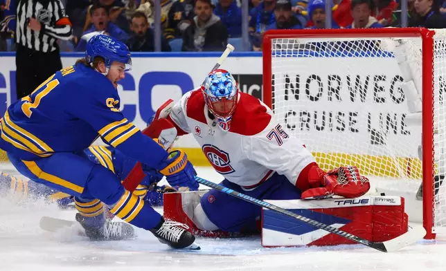 Buffalo Sabres right wing Josh Doan, left, is stopped by Montréal Canadiens goaltender Jakub Dobes (75) during the first period in Game 1 of a second-round NHL hockey Stanley Cup playoff series, Wednesday, May 6, 2026, in Buffalo, N.Y. (AP Photo/Jeffrey T. Barnes)