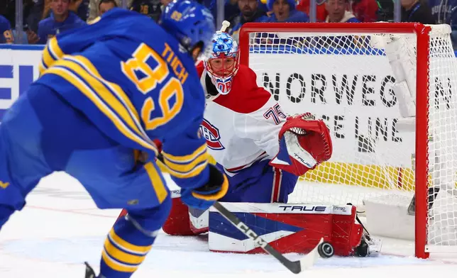 Montreal Canadiens goaltender Jakub Dobes, right, watches the puck shot by Buffalo Sabres right wing Alex Tuch (89) during the first period in Game 1 of a second-round NHL hockey Stanley Cup playoff series, Wednesday, May 6, 2026, in Buffalo, N.Y. (AP Photo/Jeffrey T. Barnes)
