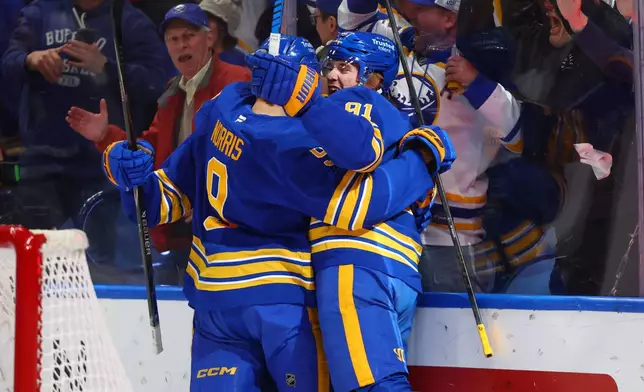Buffalo Sabres right wing Josh Doan, right, celebrates his goal with center Josh Norris, during the first period in Game 1 of a second-round NHL hockey Stanley Cup playoff series, Wednesday, May 6, 2026, in Buffalo, N.Y. (AP Photo/Jeffrey T. Barnes)