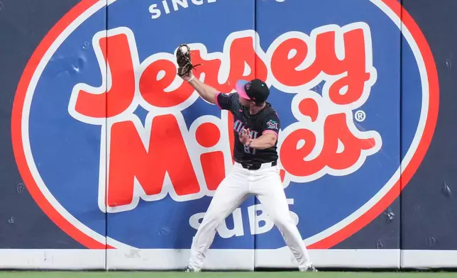 Miami Marlins center fielder Jakob Marsee catches a fly ball hit by New York Mets' Carson Benge during the first inning of a baseball game, Friday, May 22, 2026, in Miami. (AP Photo/Lynne Sladky)