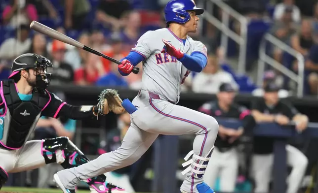 New York Mets' Juan Soto hits a single during the fourth inning of a baseball game against the Miami Marlins, Friday, May 22, 2026, in Miami. (AP Photo/Lynne Sladky)