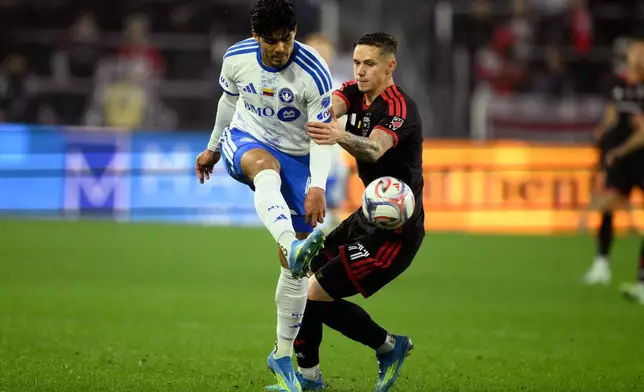 CF Montreal defender Brayan Vera, left, kicks the ball past D.C. United forward Louis Munteanu (11) during the first half of an MLS soccer match, Saturday, May 23, 2026, in Washington. (AP Photo/Nick Wass)