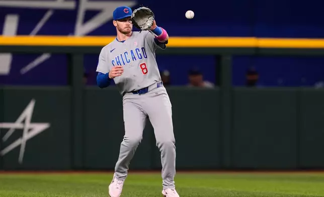Chicago Cubs' Ian Happ reaches out to glove a single by Texas Rangers' Josh Jung in the fourth inning of a baseball game Sunday May 10, 2026, in Arlington, Texas. (AP Photo/Tony Gutierrez)