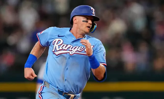 Texas Rangers' Josh Jung advances the third on a Joc Pederson double in the fourth inning of a baseball game against the Chicago Cubs Sunday May 10, 2026, in Arlington, Texas. (AP Photo/Tony Gutierrez)
