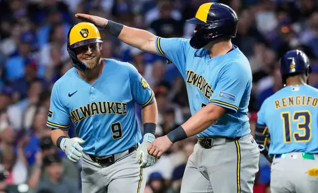 Milwaukee Brewers' Jake Bauers, left, is congratulated by Andrew Vaughn after hitting a three-run home run during the fifth inning of a baseball game against the Chicago Cubs in Chicago, Monday, May 18, 2026. (AP Photo/Nam Y. Huh)