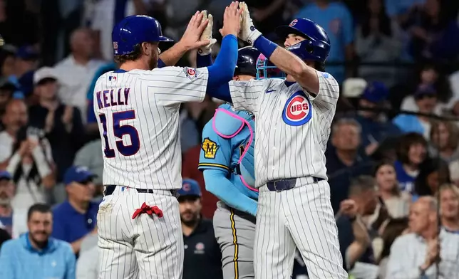 Chicago Cubs' Dansby Swanson, right, celebrates with Carson Kelly after hitting a two-run home run during the fifth inning of a baseball game against the Milwaukee Brewers in Chicago, Monday, May 18, 2026. (AP Photo/Nam Y. Huh)