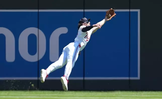 Minnesota Twins center fielder James Outman (30) catches a line out hit by Houston Astros' Christian Walker (8) during the third inning of a baseball game Wednesday, May 20, 2026, in Minneapolis. (AP Photo/Abbie Parr)