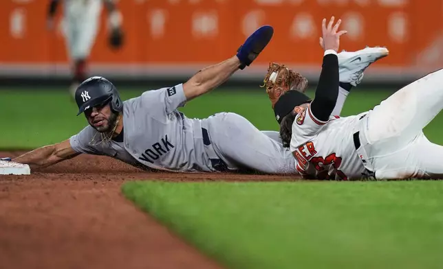 New York Yankees' José Caballero, left, is caught by Baltimore Orioles second baseman Blaze Alexander, right, while trying to steal second base during the ninth inning of a baseball game, Monday, May 11, 2026, in Baltimore. (AP Photo/Stephanie Scarbrough)