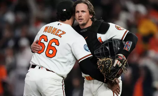 Baltimore Orioles catcher Adley Rutschman, right, and pitcher Anthony Nunez (66) celebrate after their team's victory over the New York Yankees in a baseball game, Monday, May 11, 2026, in Baltimore. (AP Photo/Stephanie Scarbrough)