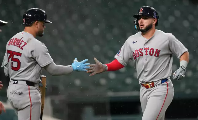 Boston Red Sox's Wilyer Abreu, right, celebrates scoring with Carlos Narváez (75) against the Detroit Tigers during the seventh inning of a baseball game Monday, May 4, 2026, in Detroit. (AP Photo/Paul Sancya)