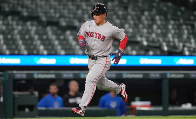 Boston Red Sox's Masataka Yoshida rounds third base on his way to score against the Detroit Tigers during the seventh inning of a baseball game Monday, May 4, 2026, in Detroit. (AP Photo/Paul Sancya)