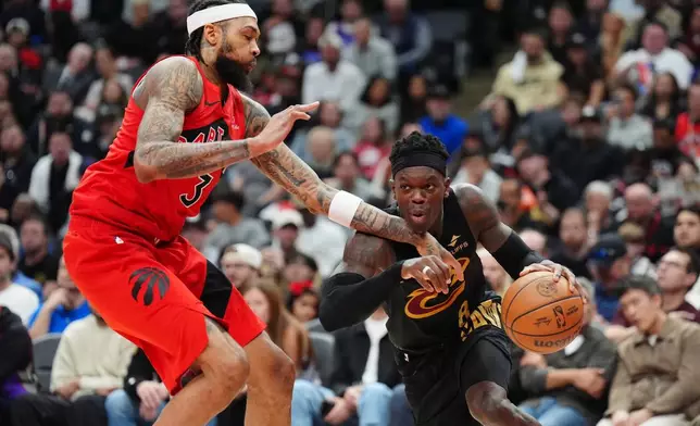 Cleveland Cavaliers guard Dennis Schroder, right, drives against Toronto Raptors forward Brandon Ingram (3) during the first half of Game 4 in a first-round NBA basketball playoffs series in Toronto, Sunday, April 26, 2026. (Frank Gunn/The Canadian Press via AP)