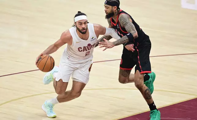 Cleveland Cavaliers guard Max Strus drives on Toronto Raptors forward Brandon Ingram during the first half in Game 5 of a first-round NBA playoffs basketball series, Wednesday, April 29, 2026, In Cleveland. (AP Photo/David Dermer)